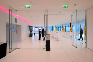 Geöffnete Glastüren zum Parkstudio mit Stehtischen mit weißen Tischdecken im Festspielhaus Bregenz