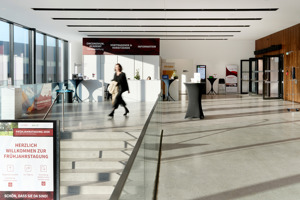 Eine Frau geht durch das helle Foyer der Werkstattbühne